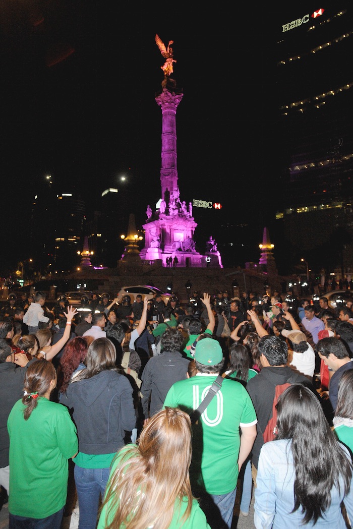 Festejo Ángel de la Independencia Cientos de aficionados de la selección llegaron al Ángel de la Independencia a festejar el triunfo ante Estados Unidos. Granaderos, acudieron al lugar, en donde encapsularon a los participantes de estos festejos para evitar desmanes. Foto: Cuartoscuro