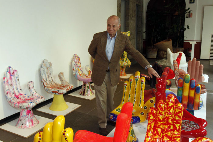 Pedro Friedeberg junto a reproducciones de su famosa Silla Mano. Foto: Notimex