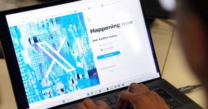 Una persona posa para una foto mientras se registra en Twitter, en una pantalla que muestra el nuevo logotipo de la plataforma, en una oficina en el centro de Londres, el lunes 24 de julio de 2023. Foto: Jonathan Brady/PA via AP