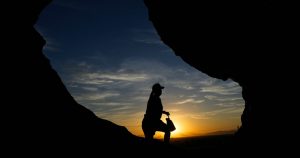 Un senderista pasa frente a la caverna Hole-in-the-Rock de Papago Park al amanecer, Phoenix, 17 de julio de 2023. Los científicos dicen que las causas principales del reciente calor extremo son el cambio climático provocado por el ser humano y el fenómeno natural "El Niño". Pero algunos dicen que necesariamente hay algo más.