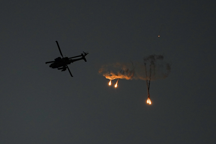 Un helicóptero Apache israelí lanza bengalas sobre la Franja de Gaza, visto desde el sur de Israel, el 1 de noviembre de 2023.