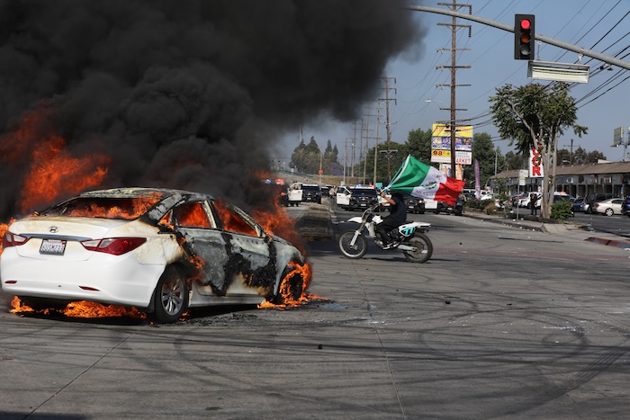 Imagen del 7 de junio de 2025 de un automóvil quemado mientras manifestantes se enfrentan con ayudantes del Sheriff de Los Ángeles, en Paramount, en el condado de Los Ángeles, California, Estados Unidos.