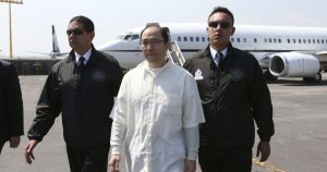 Dos elementos de la extinta PGR llevan a Zhenli Ye Gon en 2016, tras ser extraditado a México desde EU.